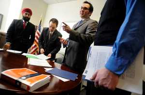 Gregory Francisco Gillett, center, and Justin Atkinson, center left, both faculty advisers of San Joaquin College of Law’s New American Legal Clinic, conduct an orientation for students, including Rajinder Sungu, left, and Zachary Stringham, right, Wednesday afternoon.
